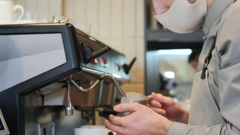 Close-up of a barista preparing latte art in a specialized cafe. A professional Stock Footage 172409261