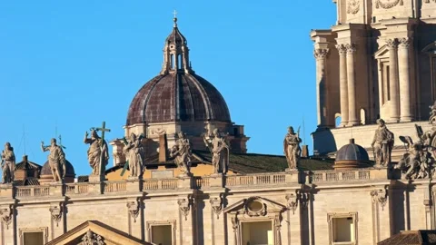 Close-up of Baroque church facade with statues and dome against clear blue sk Stock Footage 335209697