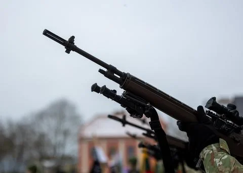 A close-up of the barrel of the m-16 machine gun on a blurred background Stock Photos