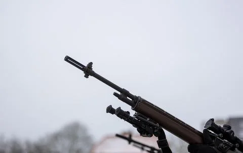 A close-up of the barrel of the m-16 machine gun on a blurred background Stock Photos