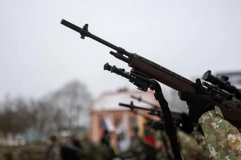 A close-up of the barrel of the m-16 machine gun on a blurred background Stock Photos