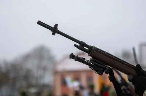 A close-up of the barrel of the m-16 machine gun on a blurred background Stock Photos