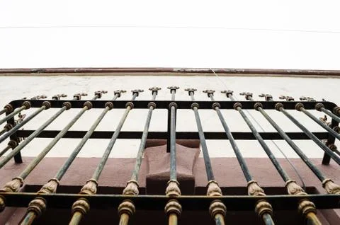 Close-up of bars on an old window, purple colors with beige and white, backgr Stock Photos