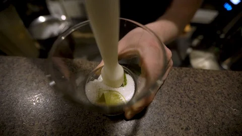 Close up bartender crushing lime in cocktail Stock-Footage 104017965