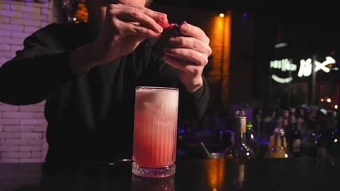 Close-up of bartender decorating sides with strawberry cocktail at bar Stock Footage 269544115