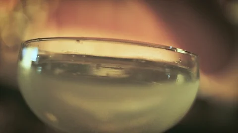 Close up of bartender dropping an olive in cocktail glass Stock Footage 103854101