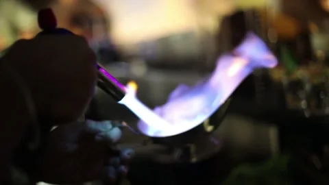 Close-up of bartender lighting up a cup of alcohol with a flame Stock Footage 194375932