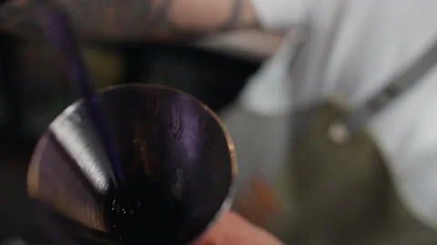 Close-up of a bartender pouring alcohol into a jigger at the bar. Stock Footage 229897959