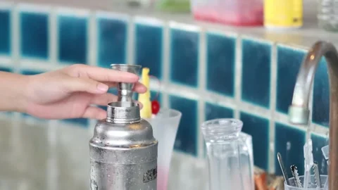 Close Up of Bartender Pouring Red Liquid into a Metal Shaker Stock Footage 327831859