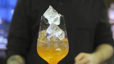 Close-up of a bartender putting ice in a cocktail Stock Footage 247027350