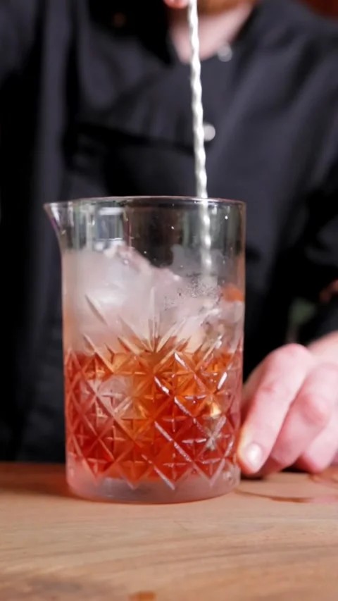 Close-up of Bartender Stirring Drink with Long-Handled Spoon, Vertical Video Stock Footage 288577570