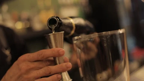 Close up of Bartender Using Jigger to Measure Champagne For a Drink Stock Footage 129781342