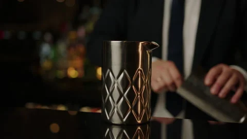 Close-up of a bartender who puts ice in a metal glass Stock Footage 219116241