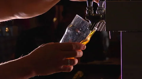 Close-up of a bartender's hands pouring beer into glass from a restaurant tap. Stock Footage 47218686