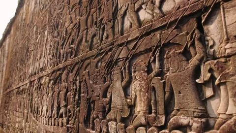 Close up of bas relief carving on an ancient sandstone wall at the bayon temple Stock Footage 325073132