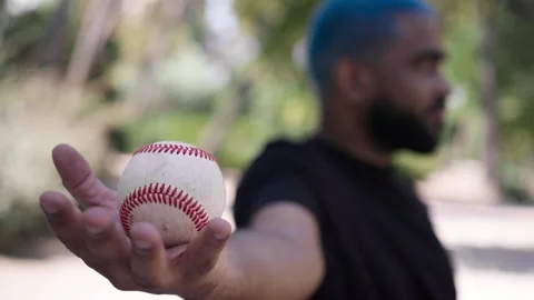 Close-up of baseball ball in hands of african american black man Stock Footage 287488564