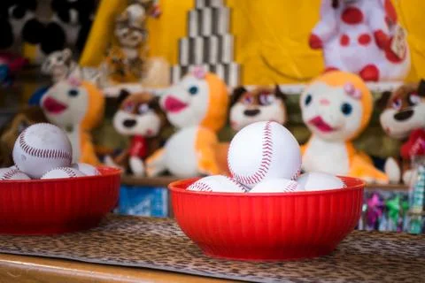Close-up of baseball balls for the game of throw at jars in a fair. In the ba Stock Photos