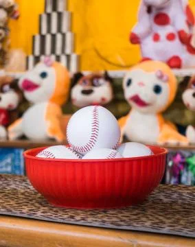 Close-up of baseball balls for the game of throw at jars in a fair. In the ba Stock Photos