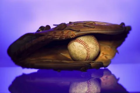Close-up of a baseball in a baseball glove Stock Photos