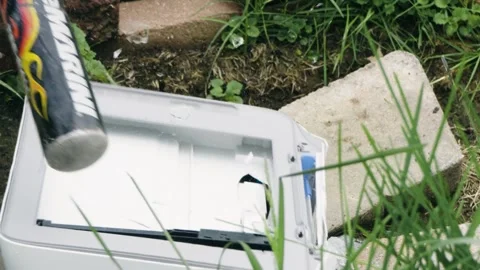 Close up baseball bat hitting office printer in frustration upset mood 動画素材 276340299