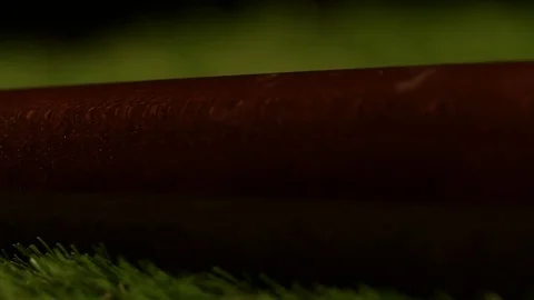 Close up of a baseball bat spinning slowly to reflect stadium lights. Stock Footage 72536615