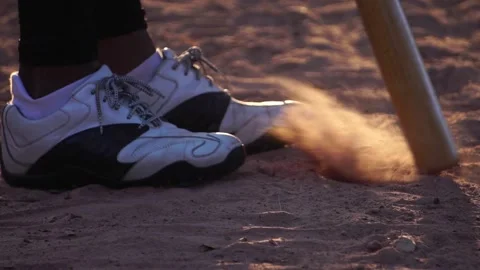 A close-up of baseball shoes dealing with the surface of the game field Stock Footage 143912539