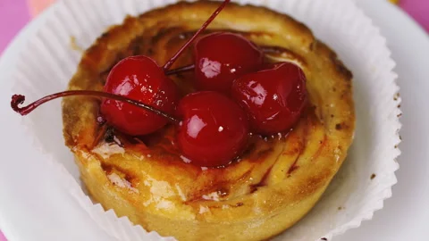 Close up basket cake with icing and cherries.  Stock Footage 101674502