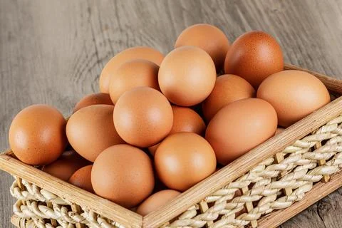 Close up of a basket of fresh raw Brown Eggs Stock Photos