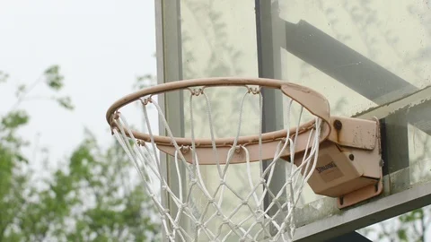 Close up of a basketball going in the hoop Stock Footage 128643448