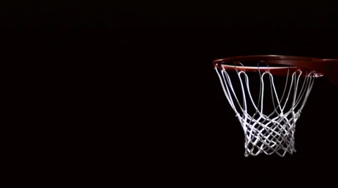 Close up of a basketball going through the net for a field goal Stock Footage