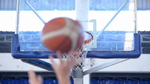 Close up of a basketball going through the net for a field goal. Stock Footage 97522569