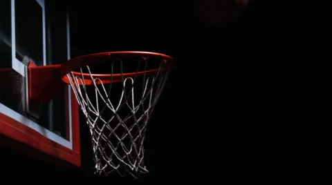 Close up of a basketball hitting the rim of the hoop and bouncing away Stock Footage