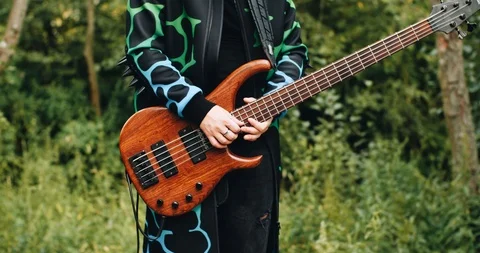 Close-up of a bass player playing in an old abandoned Park. Great musician. Stock Footage 114520085