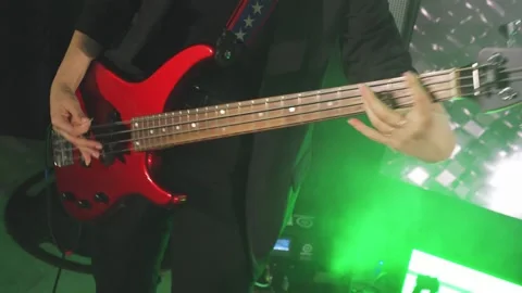 Close-up of bass players hands while playing guitar at live music concert Video stock 312768313