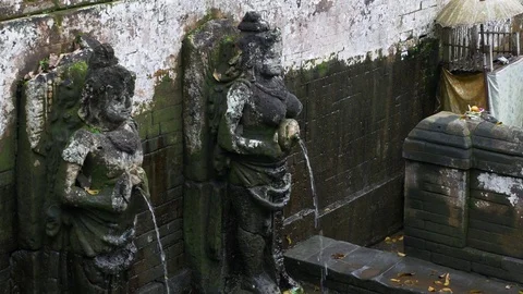 Close up on bathing temple figures at Goa Gajah Elephant cave in Ubud Bali Video stock 84640586