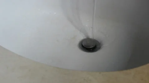Close on Bathroom Sink Drain With Water Flowing Down (27) Видео 24757513