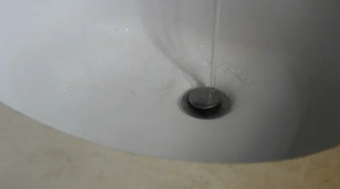 Close on Bathroom Sink Drain with Water Flowing Down Gets Turned Off (28) Stock Footage 24757541