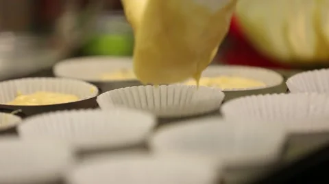 Close up of batter being poured into muffin tray Stock Footage 61349709