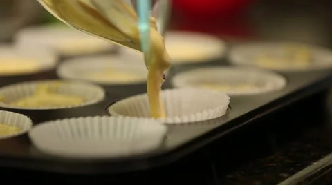 Close up of batter being poured into muffin tray Stock Footage 61350083