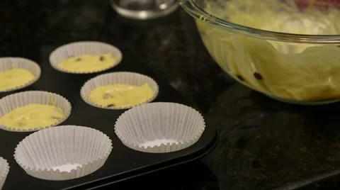 Close up of batter being poured into muffin tray Stock Footage 61351561