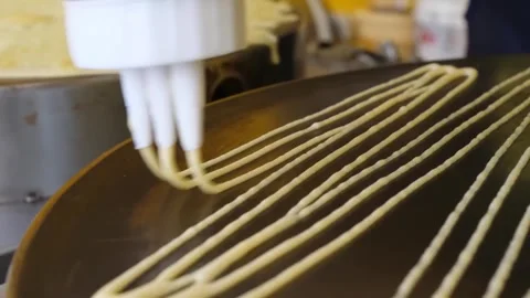 Close-up of Batter Poured in Strips on a Griddle to Make Crepes Stock-Footage 345692454