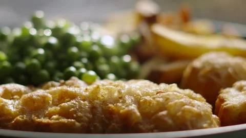 Close Up of Battered Cod Fish Fillet on Plate with French Fries Chips and Stock Footage 283344072