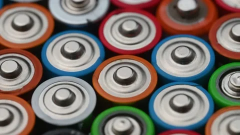 Close-up batteries rotating on a turntable, top view. Hazardous waste concept Stock Footage 233957237