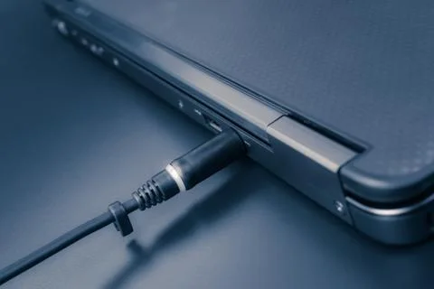 Close up of battery charge on laptop computer with power plug Stock Photos