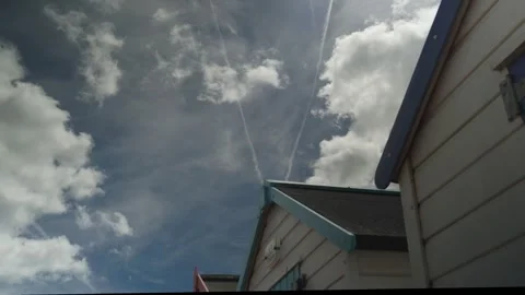 Close up of beach huts by the sea clouds passing by Stock Footage 338033397