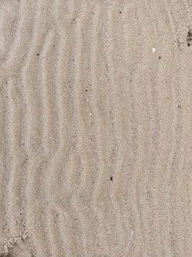 Close-up of beach sand with wind shaped ripples natural texture Fotos Stock