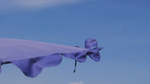 Close up of beach straw umbrella corner with blue sky and clouds at the seaside Stock-Footage 129482718