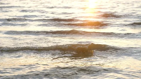 Close up beach with sunset reflected on surface Stock Footage 68008173