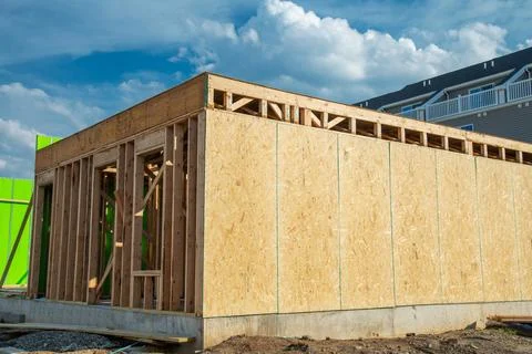 Close-up of beam built home under construction and blue sky with wooden truss Stock Photos