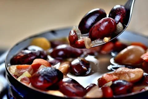 Close-up of bean soup with large beans in an old enamel pot Stock Photos
